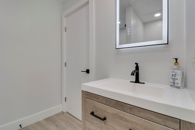 bathroom with vanity and hardwood / wood-style flooring