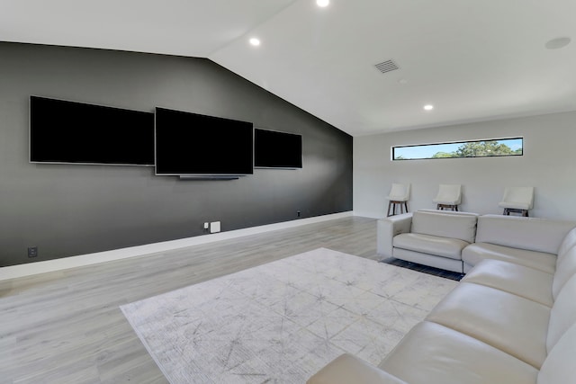 living room with lofted ceiling and light hardwood / wood-style flooring