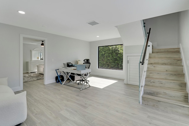 office area with light hardwood / wood-style floors and ceiling fan