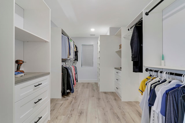 spacious closet featuring light hardwood / wood-style floors