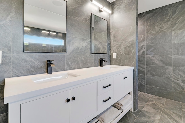 bathroom with vanity and tile walls