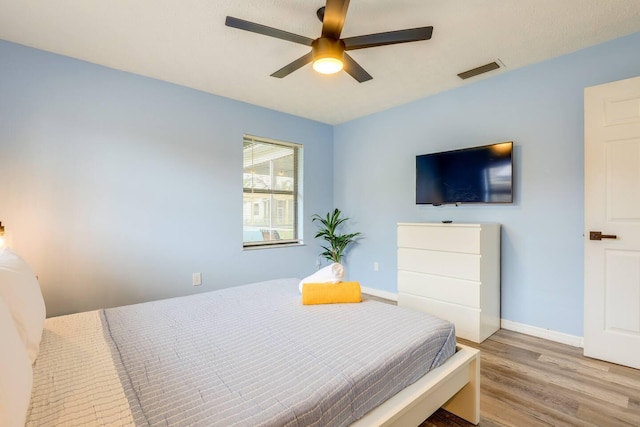 bedroom featuring light hardwood / wood-style floors and ceiling fan