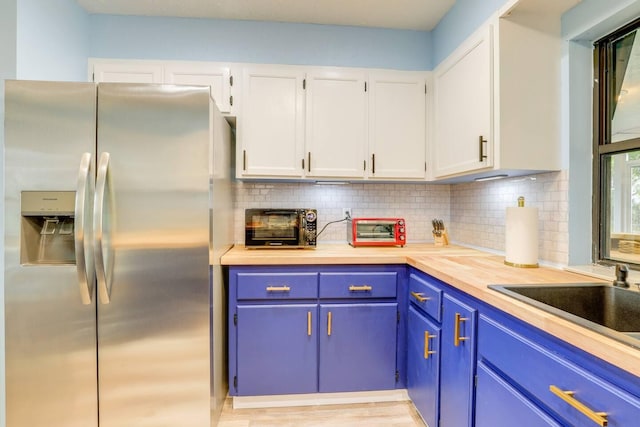 kitchen with backsplash, wooden counters, white cabinets, light hardwood / wood-style floors, and stainless steel fridge with ice dispenser