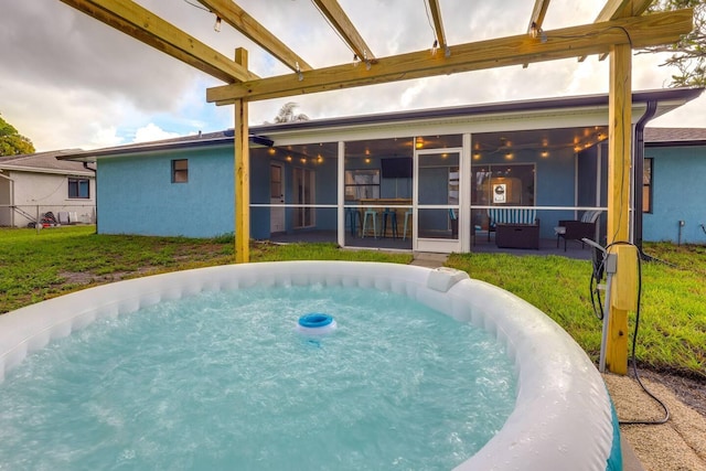 view of swimming pool with a sunroom and a yard