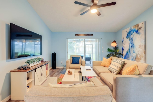 living room featuring light hardwood / wood-style floors, vaulted ceiling, and ceiling fan