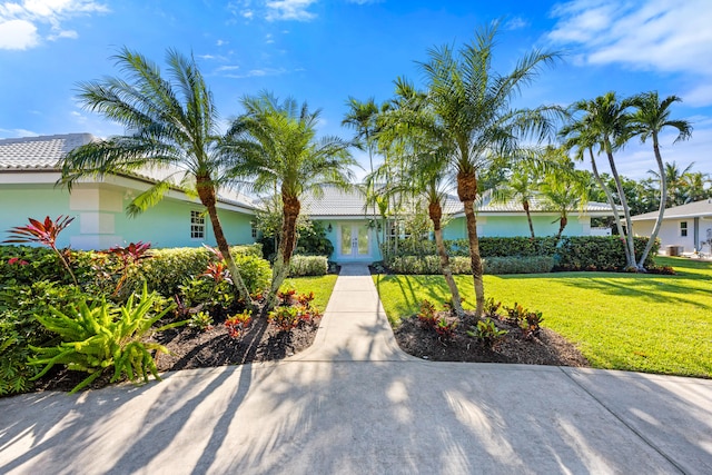 view of front of house featuring french doors and a front lawn