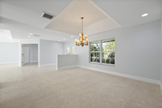 spare room featuring a chandelier