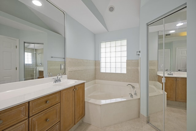 bathroom featuring tile patterned flooring, lofted ceiling, and a healthy amount of sunlight