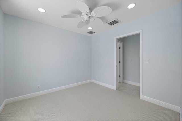 spare room with light carpet and ceiling fan