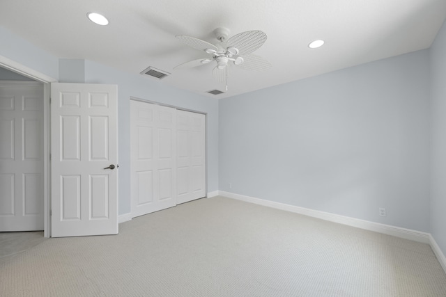 unfurnished bedroom featuring carpet, ceiling fan, and a closet