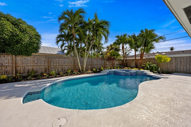 view of pool featuring an in ground hot tub and a patio area