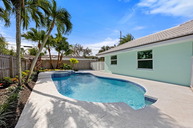 view of swimming pool featuring an in ground hot tub and a patio