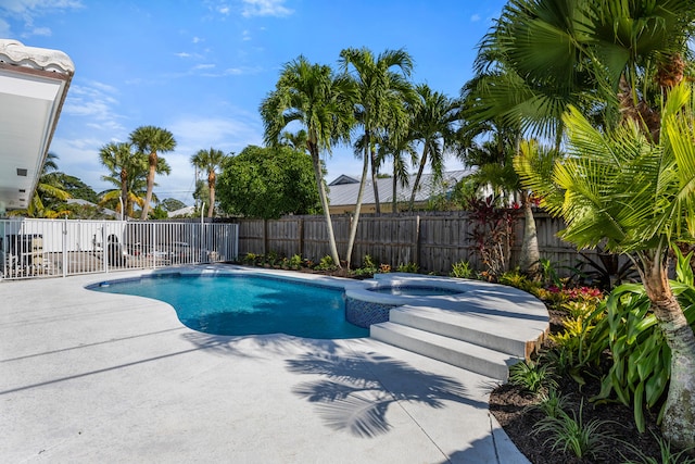 view of pool with a patio area and an in ground hot tub