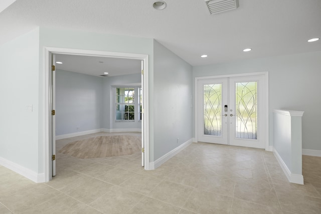 tiled entrance foyer with french doors and plenty of natural light