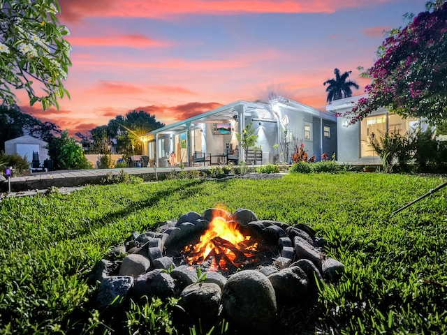 yard at dusk with an outdoor fire pit