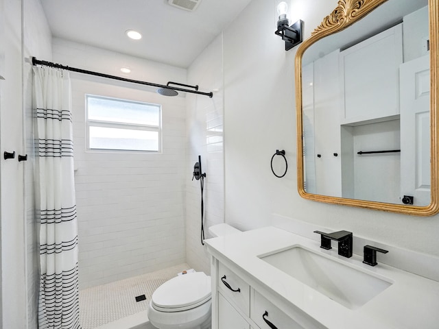 bathroom featuring vanity, toilet, and curtained shower