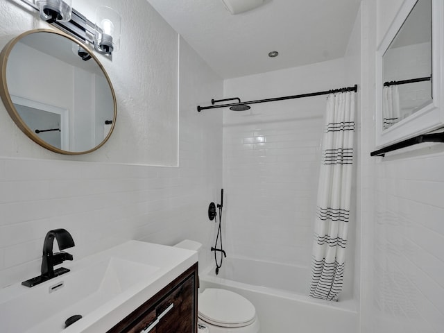 full bathroom with tile walls, vanity, shower / bath combo, and toilet