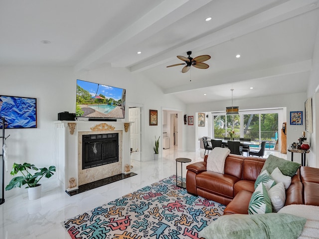 living room featuring vaulted ceiling with beams, ceiling fan, and a premium fireplace