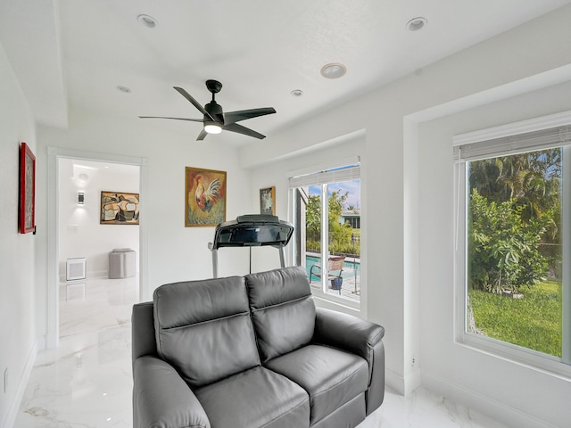 living room with ceiling fan and plenty of natural light