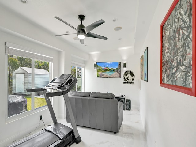 exercise room with ceiling fan