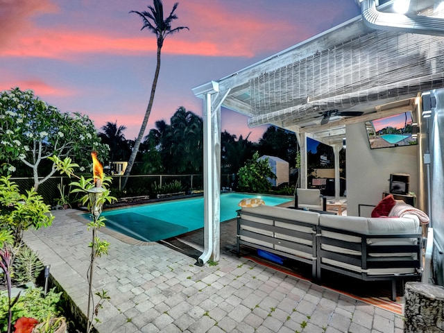 view of swimming pool with outdoor lounge area, ceiling fan, and a patio area