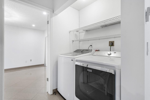 kitchen featuring white cabinets, sink, light tile patterned flooring, and black appliances