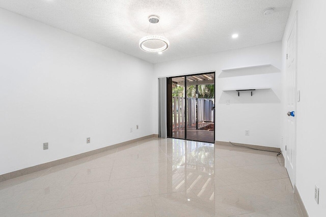 unfurnished bedroom with light tile patterned flooring, a textured ceiling, and two closets