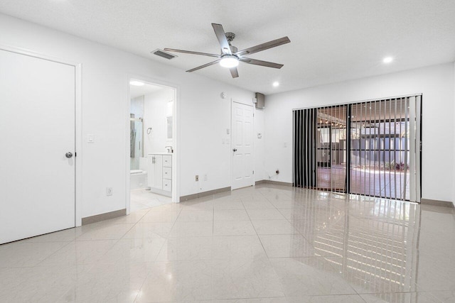 spare room featuring ceiling fan and a textured ceiling