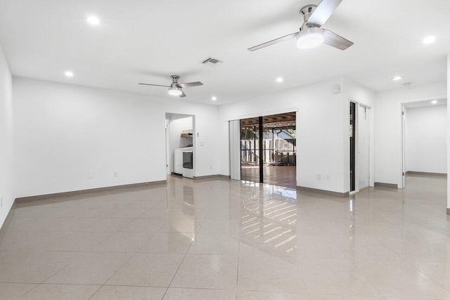 interior space with washer / dryer, ceiling fan, and light tile patterned flooring