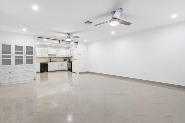 interior space with ceiling fan and washer / dryer