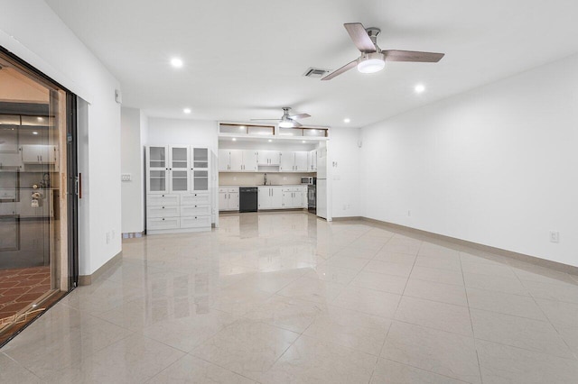 unfurnished living room featuring light tile patterned flooring, ceiling fan, and sink