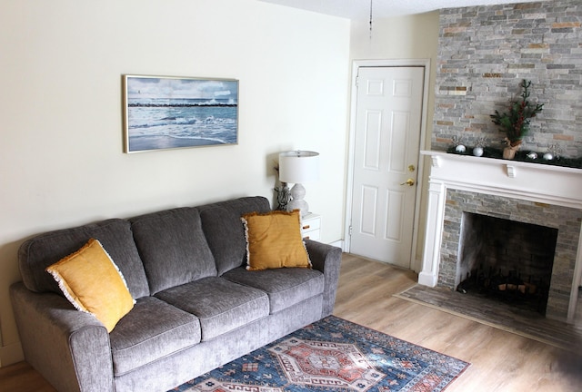 living room with a fireplace and light hardwood / wood-style floors