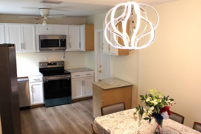 kitchen with ceiling fan, white cabinets, stainless steel appliances, and light hardwood / wood-style flooring