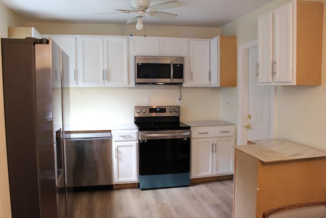 kitchen with ceiling fan, appliances with stainless steel finishes, light hardwood / wood-style flooring, and white cabinetry