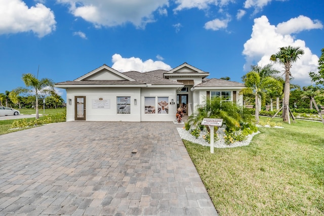 view of front of house with a front yard and a garage