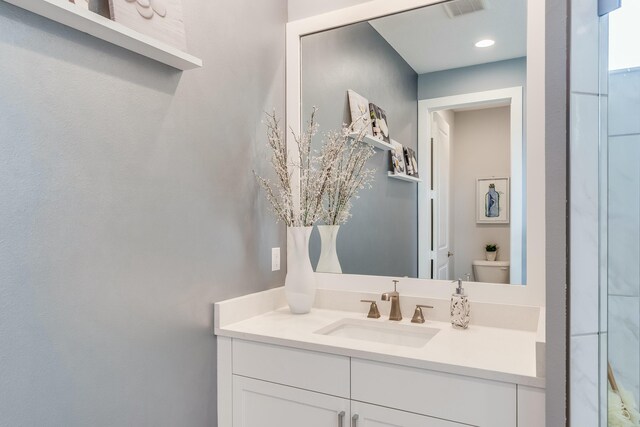 bathroom featuring vanity and toilet