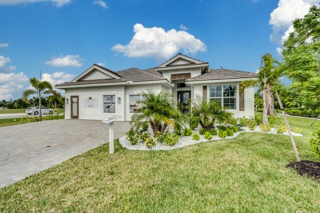 view of front of property with a garage and a front lawn