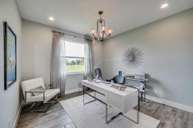 office area with a chandelier and light hardwood / wood-style flooring