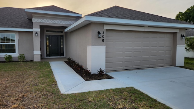206 Riomar Dr, Port Saint Lucie, FL 34952 - entrance to property featuring an attached garage, roof with shingles, stucco siding, and driveway