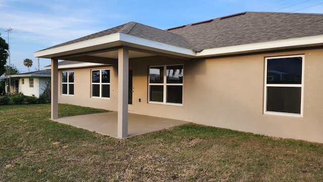 206 Riomar Dr, Port Saint Lucie, FL 34952 - back of property with a yard, a patio area, a shingled roof, and stucco siding