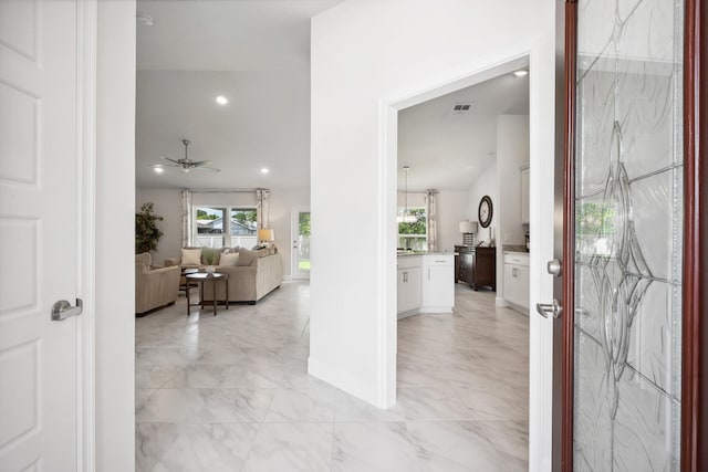 foyer entrance with ceiling fan