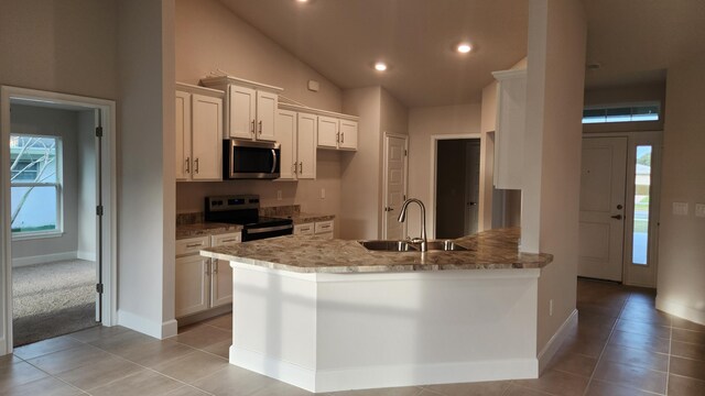 206 Riomar Dr, Port Saint Lucie, FL 34952 - kitchen featuring a sink, light tile patterned flooring, baseboards, appliances with stainless steel finishes, and light stone countertops