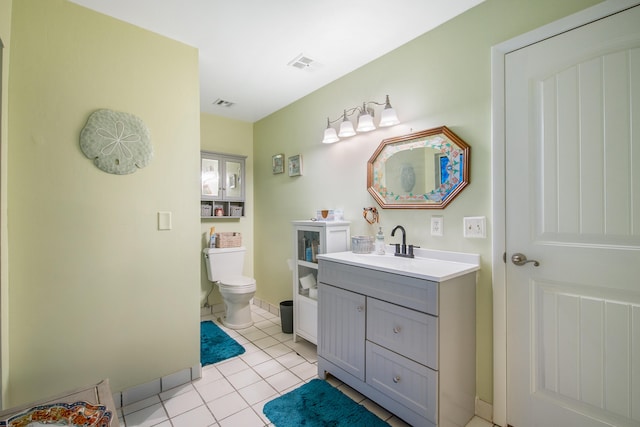 bathroom with tile patterned flooring, vanity, and toilet