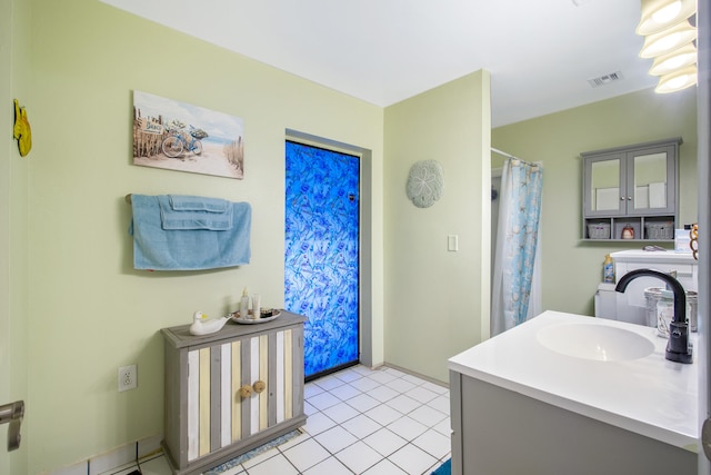 bathroom with walk in shower, tile patterned floors, and vanity