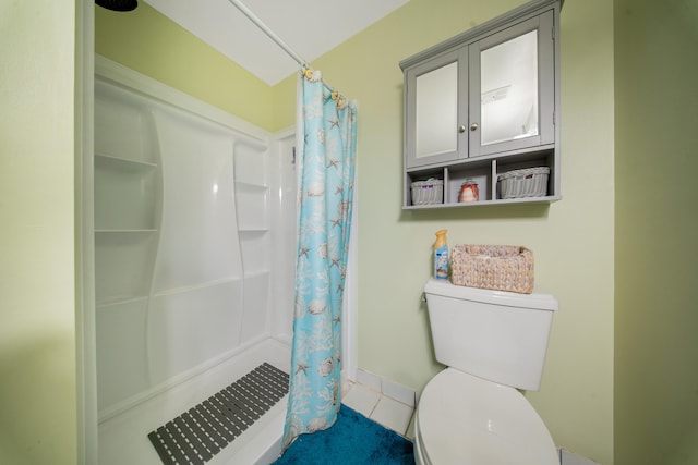 bathroom with tile patterned flooring, toilet, and a shower with curtain