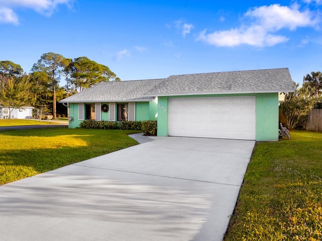 ranch-style house featuring a garage and a front lawn