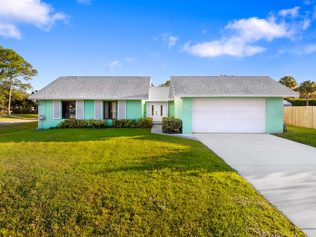 ranch-style house featuring a garage and a front lawn