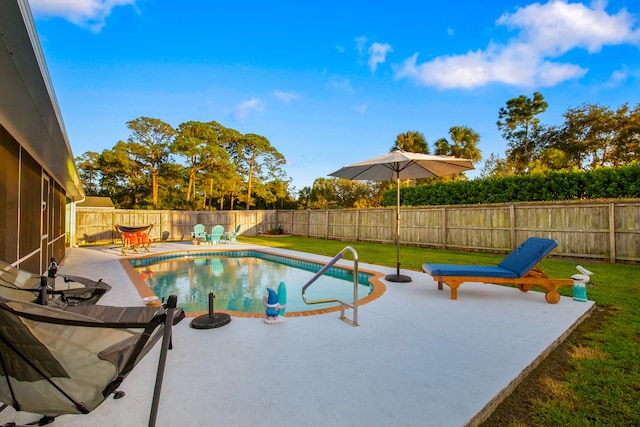 view of swimming pool with a lawn and a patio