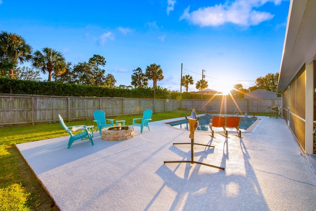 view of patio / terrace with a fenced in pool and a fire pit