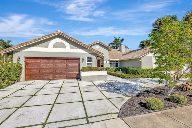 mediterranean / spanish-style house with a garage